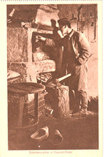 AK  -Schmiede-  Schmied zerkleinert Holz mit Beil für das Schmiedefeuer