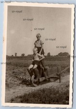 Jungs auf alter Schubkarre auf