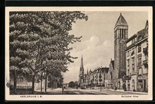 AK Karlsruhe i. B., Durlacher Allee mit Geschäft und Kirche, Strassenbahn 1915 