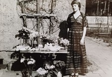 Mädchen steht im typischen 70er Jahre Kleid am Gabentisch Jugendweihe DDR Foto