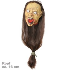 Schrumpfkopf mit langen Haaren