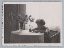 Mädchen beim Schreiben am Tisch - Zeitlose Aufnahme Foto