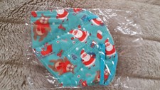 bunt - türkiser FFP2 - Mundschutz mit Weihnachtsmännern & Weihnachtsmotiven
