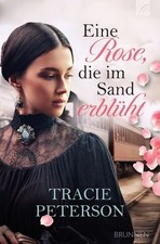 Eine Rose, die im Sand