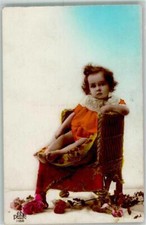 39681463 - Ein Kleinkind auf einem Sessel mit Rosen zu seinen Fuessen DEDE