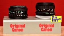 Zwei Canon-FD-Objektive 35 mm und 50 mm mit einem Original-Canon-Werbeaufsteller