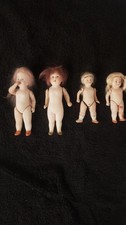 4  antike Puppen aus