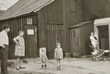 Familie steht vor Scheune