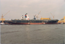 Foto Abzug : großes Containerschiff am Kai mit Schleppern