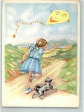 39738540 - Maedchen mit kleinem Hund laesst einen Drachen steigen Kind