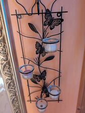 Wanddekor aus Metall mit Teelichtern