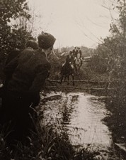 Reiter reiten durch eine Furt