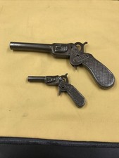 2 x Blech-Spielzeug Knallkorken-Pistole Stöpsel- Kartoffelpistole DRGM-TIP