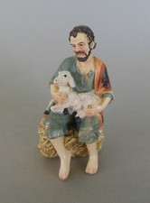 Hirte mit Lamm sitzend auf