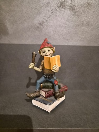 Pixies figure sitting a - pixies™, on