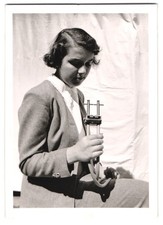 Fotografie junge Frau betrachtet eine Punktschweißzange 