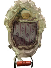 Miniatur-Kinderwagen mit Puppe