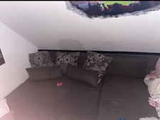 Schlafcouch mit Bettkasten, in einer L Form in der Farbe grau, als Doppelbett 