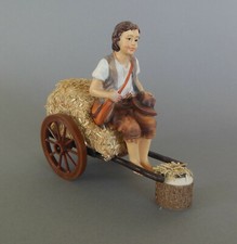 Hirte auf Strohwagen sitzend