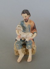 Hirte mit Lamm sitzend auf