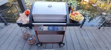 Gasgrill Campingaz Woody 3, drei Brenner,  Edelstahlrost, Haube, Drehspieß