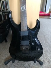 Cort EVL-X7 E-Gitarre, schwarz, aktive mit Floyd-Rose. Mahagoni/Ahorn/Palisander