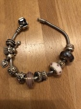 Original Pandora Armband mit 12 Original Pandora Charms mit Gold und Rubin, Clip