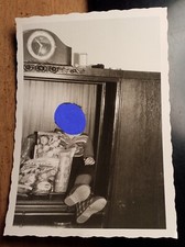 Little Boy Sitting in Cupboard