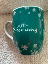 Kaffeetasse "Gute Besserung" tetesept grün weiße Schrift und Schneeflocken
