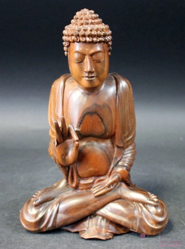 Buddhafigur aus dunklem holz - aus,