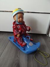 Baby Born Puppe mit Schlitten & Helm - rosa Augen