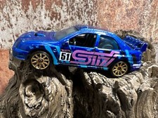 Subaru Impreza STI #51, GRAVEL, bl. goldene F.Hot Wheels Japan Rally Modellauto