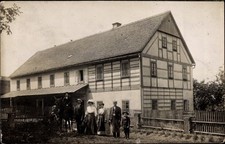 Foto Ak Arnsdorf in Sachsen, Personen vor einem Wohnhaus - 3820477