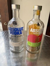 3x farbig beschriftete Glas-Flasche „Absolut Vodka“, gebr. zur Wiederbefüllung