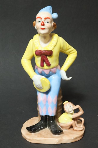 Bunte clownfigur mit affe - clownfigur,