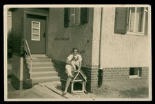 Pekingese Dog on Arm by