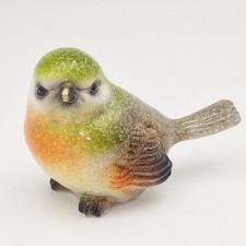 Vogel grün orange braun