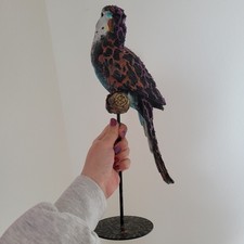 budgie statue with a dark side