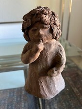 Girl with thumb in mouth, clay
