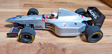 Vintage Tamiya F103 F1 RC car with a silver painted body