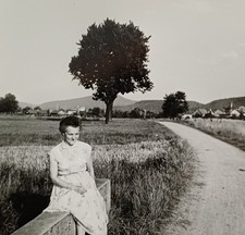 Frau sitzt schüchtern auf