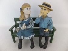 CANDY DESIGN NORWAY Mädchen + Junge mit Süssigkeit + Buch auf Bank  Carl Larsson