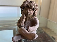 Girl/child sitting, clay