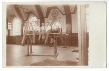 Sports gymnast at bar gym