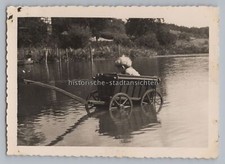 Boy in handcart in pond - old