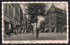 Ansichtskarte Neumünster-Holstein, Strasse Kuhberg mit Geschäften 1938 