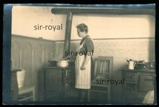Woman in Kitchen at Stove -