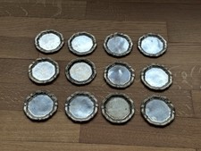 12 Silberne Untersetzer -