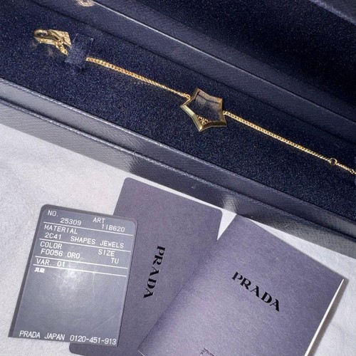 Prada stern gold metall - prada,